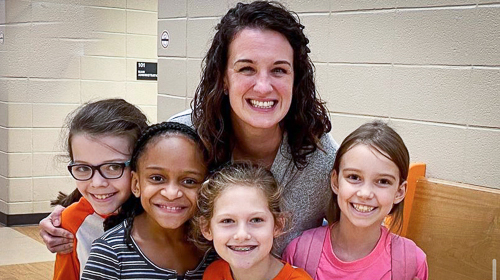  Dr. Jillian Johnson is with some students at A.L. Burruss Elementary School.